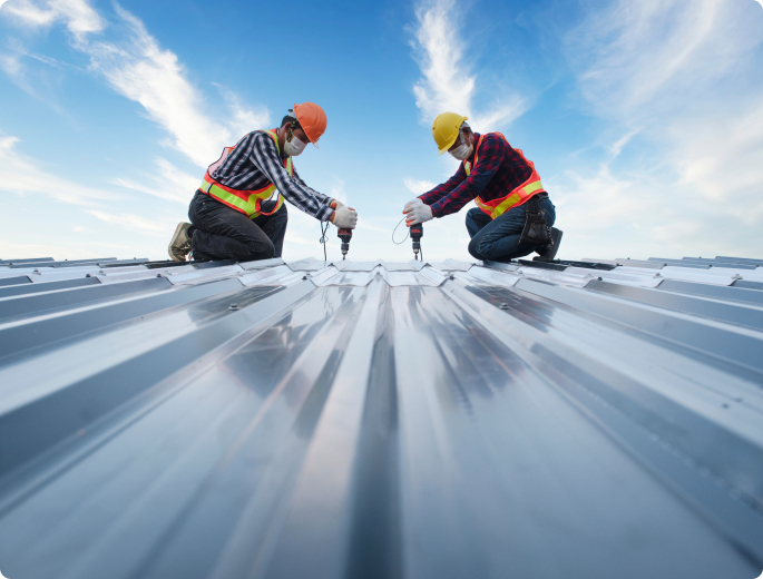 men working on metal buildings