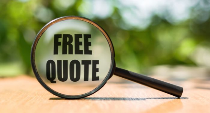 A metal building magnifying glass featuring the word "free quote.