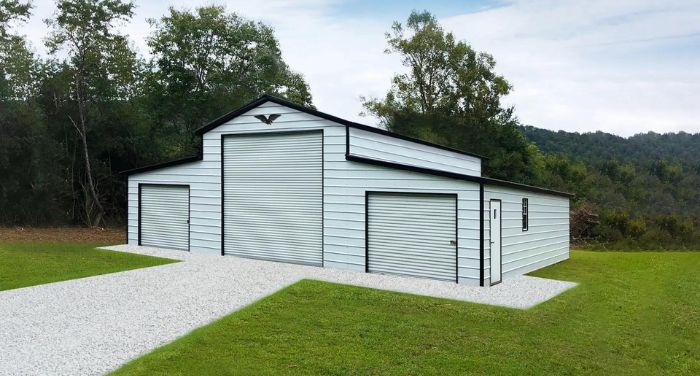 A bargain metal garage with two doors and a grassy area.