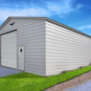 A 28X40X12 Vertical Roof Metal Garage with a garage door in a backyard.