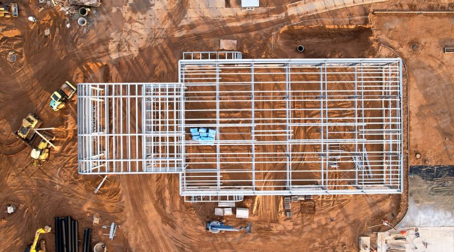 An aerial view of the best metal building companies constructing a building.