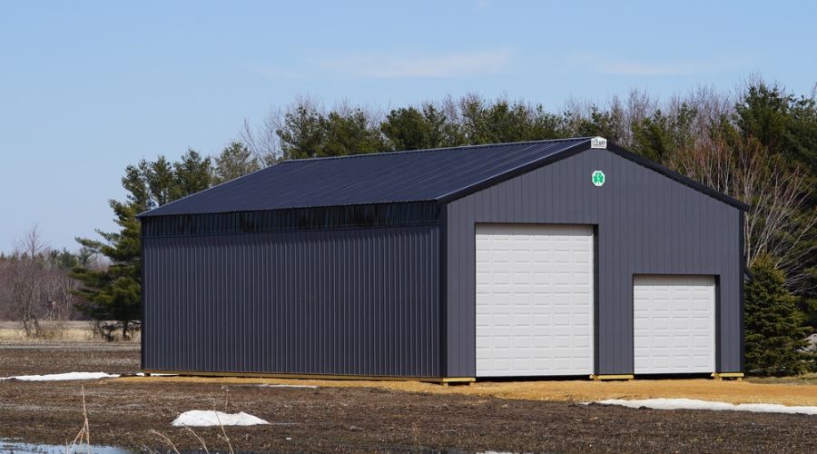 A cost breakdown of a gray metal garage with a garage door.